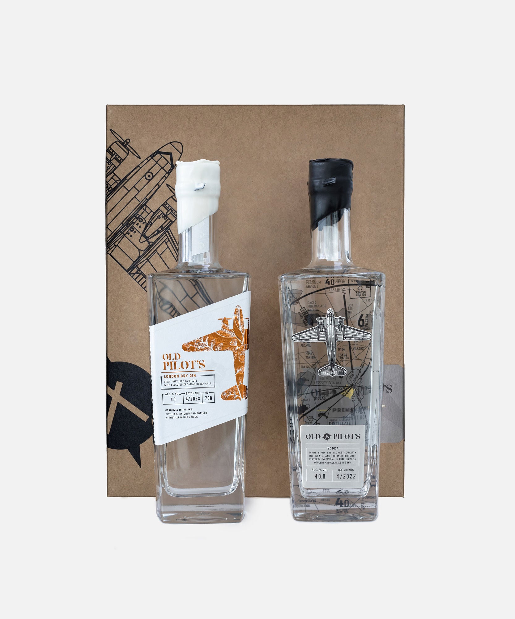 A gift package containing two bottles of alcohol and a jigger, presented in a rectangular box with a graphical design.